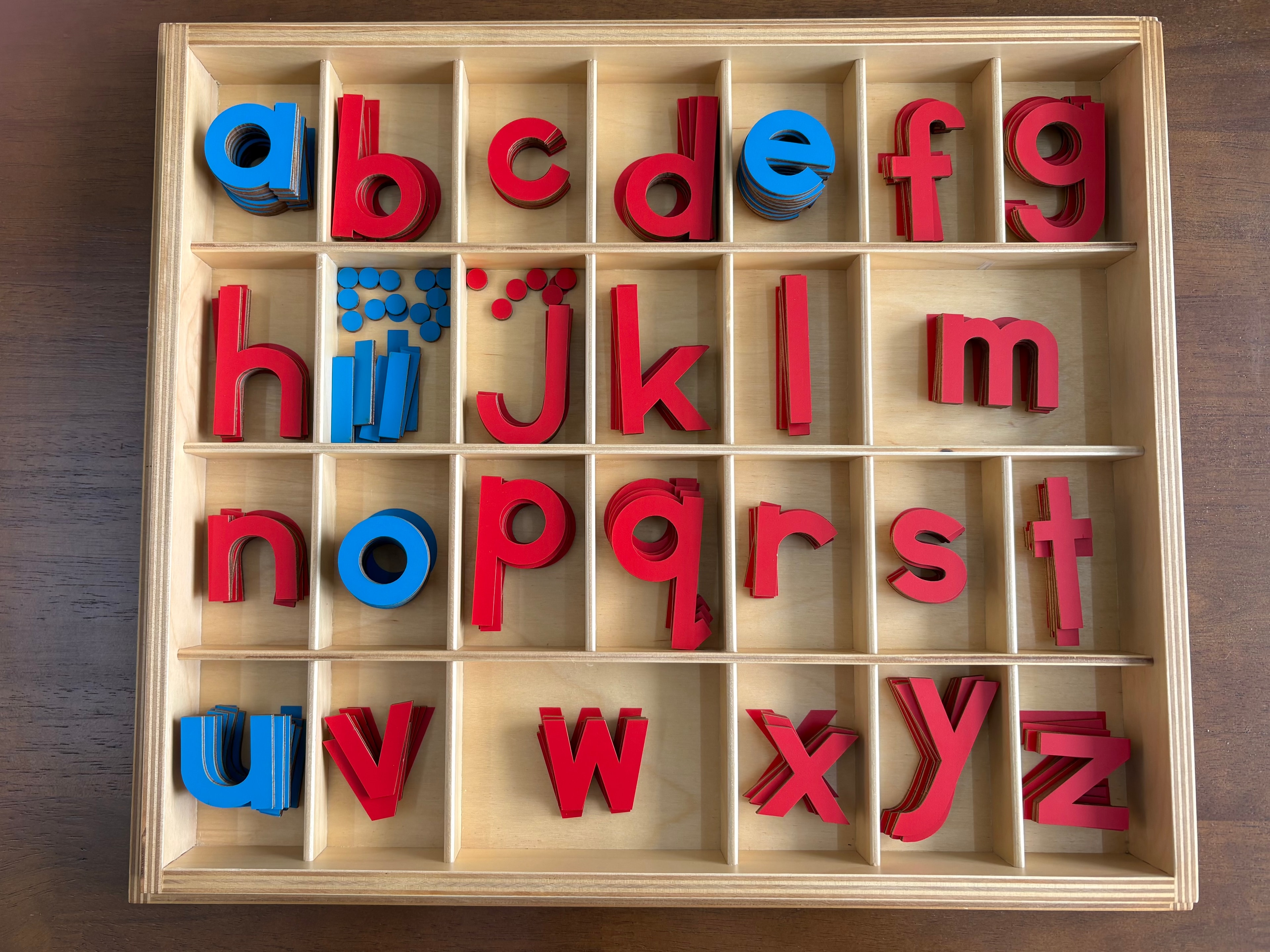 Wooden Montessori Movable Alphabet box filled with red and blue letter tiles from a to z